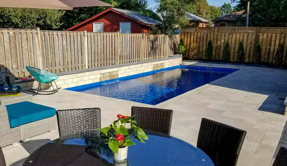 Leisure Pools Denver shows a stylish backyard pool area perfect for relaxing or gathering with friends and family.